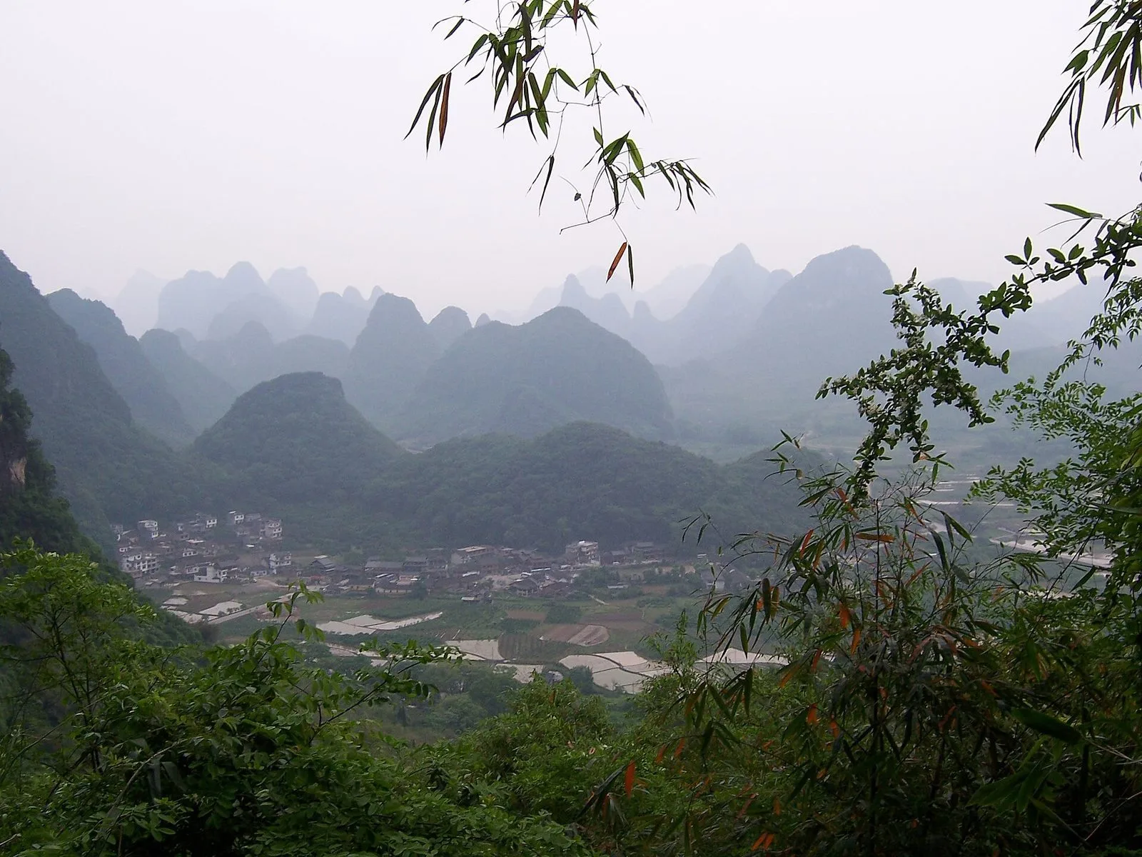 Yangshuo karst landscape, Guilin — villages and rice paddies between limestone peaks