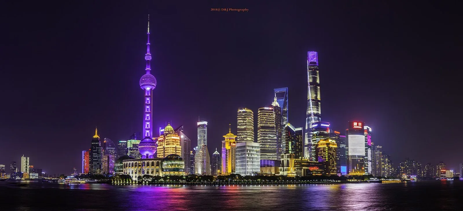 Shanghai Pudong skyline lit up at night viewed from the Bund